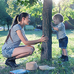 Mother and son playing in a park.